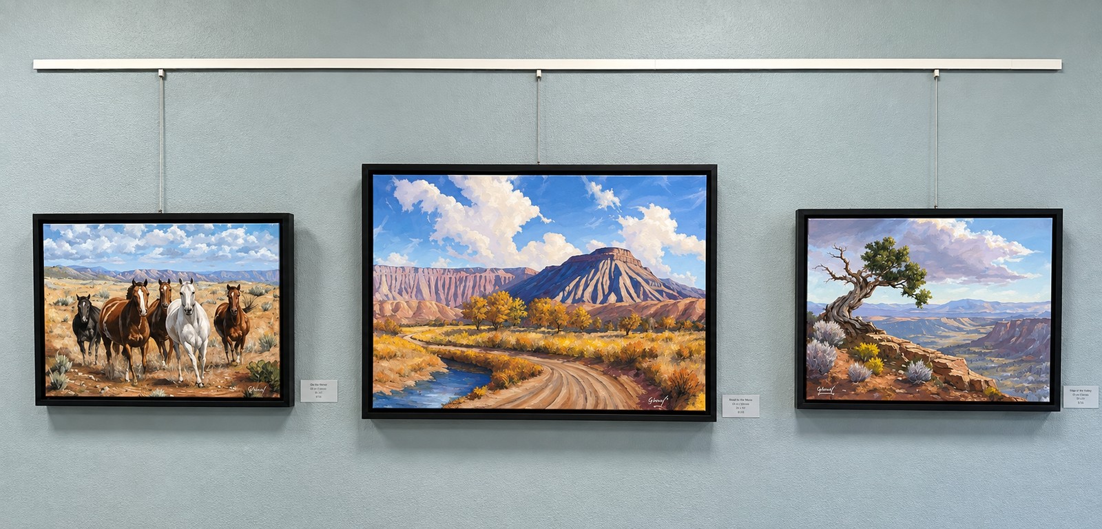 Three oil paintings by George Wood on display at the Grand Junction Convention Center